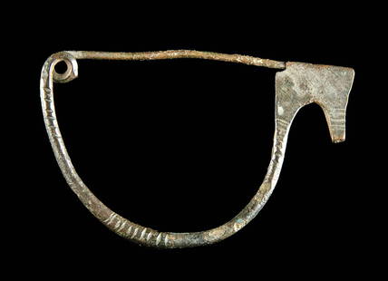 Etruscan Bronze Bow Type Fibula Pin: **Originally Listed At $350** Central Italy, Etruria, ca. 600 to 400 BCE. A fine bronze bow shaped fibula pin for a cloak or tunic made from a thick wire in a semi-circular shape. One end is hammered