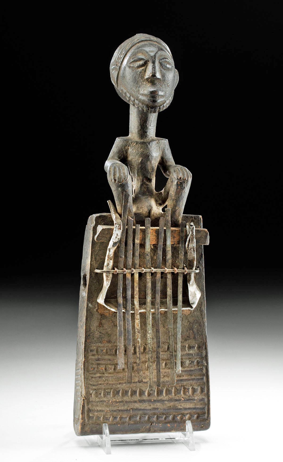 19th C. African Hemba Wood & Iron Mbira Instrument: Central Africa, Dominican Republic of Congo, Hemba peoples, ca. 19th to 20th century CE. A mbira, also known as a finger harp, thumb piano, or sanza- a musical instrument and work of art popular throu
