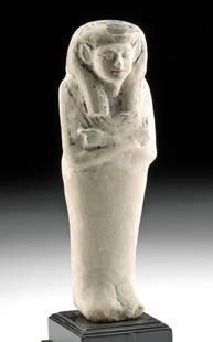 Published Egyptian New Kingdom Limestone Ushabti: Ancient Egypt, New Kingdom, 19th Dynasty, ca. 1292 to 1189 BCE. A gorgeous ushabti figure carved by hand from gray-white limestone exhibiting a slender form. The figure presents standing in mummiform