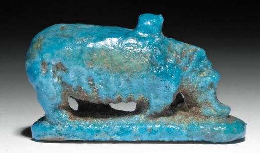 Rare Egyptian Faience Hippopotamus Pendant: Ancient Egypt, Third Intermediate Period, 21st to 25th Dynasty, ca. 1070 to 664 BCE. An extremely rare and desirable pendant depicting a hippopotamus as it grazes on the lush vegetation beneath it.