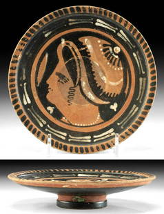 Greek Apulian Pottery Plate w/ Lady of Fashion: Magna Graecia, southern Italy, Apulia, ca. 340 to 325 BCE. A stunning red-figure plate on a raised foot featuring a "Lady of Fashion" wearing a saccos - head scarf - with pearl strands and hair pins,