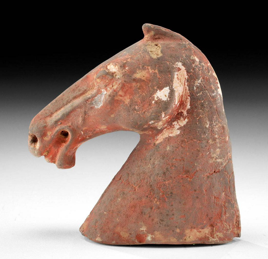 Chinese Han Dynasty Pottery Horse Head: East Asia, China, Han Dynasty, ca. 206 BCE to 220 CE. A fine mold-made pottery horse head displaying a lively visage with bulging eyes, a pronounced snout with flared nostrils, and an open mouth revea