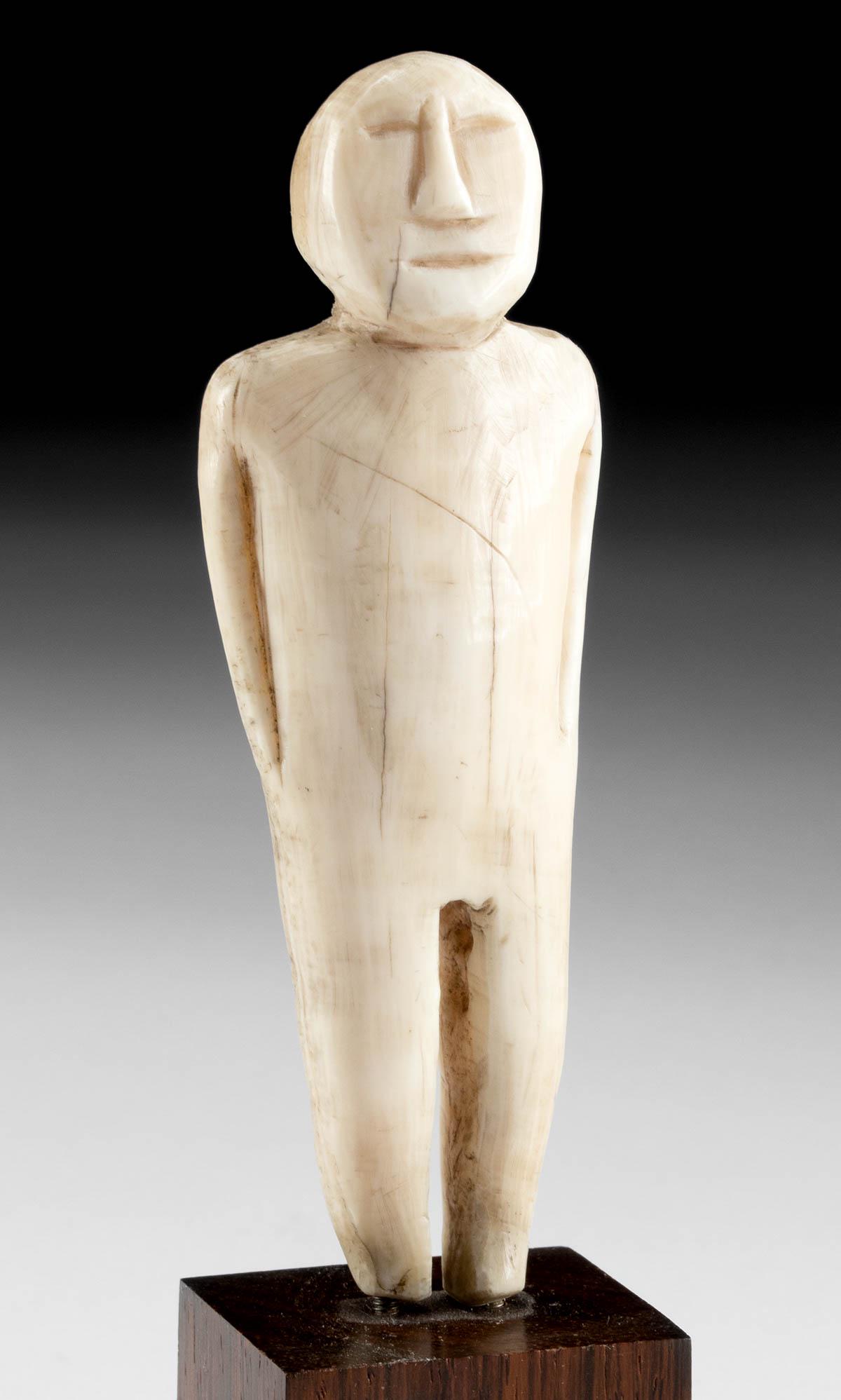 Pre-Contact Yupik Thule Walrus Ivory Figure: Native American, Northwestern United States, Alaska, Inuit or Yupik peoples, Thule and Pre-Contact period, ca. 1200 to 1700 CE. A rare effigy idol of a miniature size, hand-carved from walrus tusk ivo