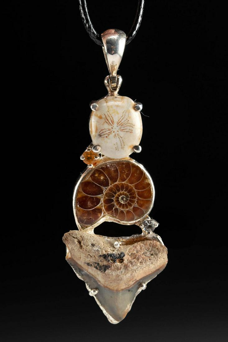 Sterling Silver Pendant w/ Topaz & Marine Fossils: North America, ca. millions of years ago. A lovely sterling silver pendant that contains 3 marine fossils and 2 topaz gemstones. The pendant is strung on a modern cord with a lobster clasp as a ready