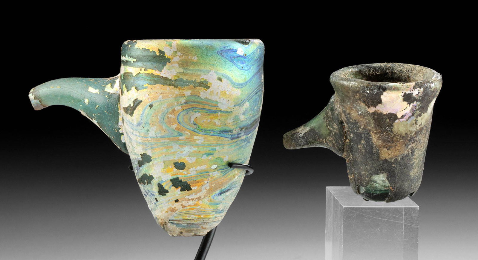 2 Roman Glass Baby Feeders w/ Funnel Spouts: **First Time At Auction** Roman, Imperial period, ca. 1st to 2nd century CE. A pair of beautiful free blown glass "baby feeders" in aqua blue and semitransparent green hues. Both are shaped with a con