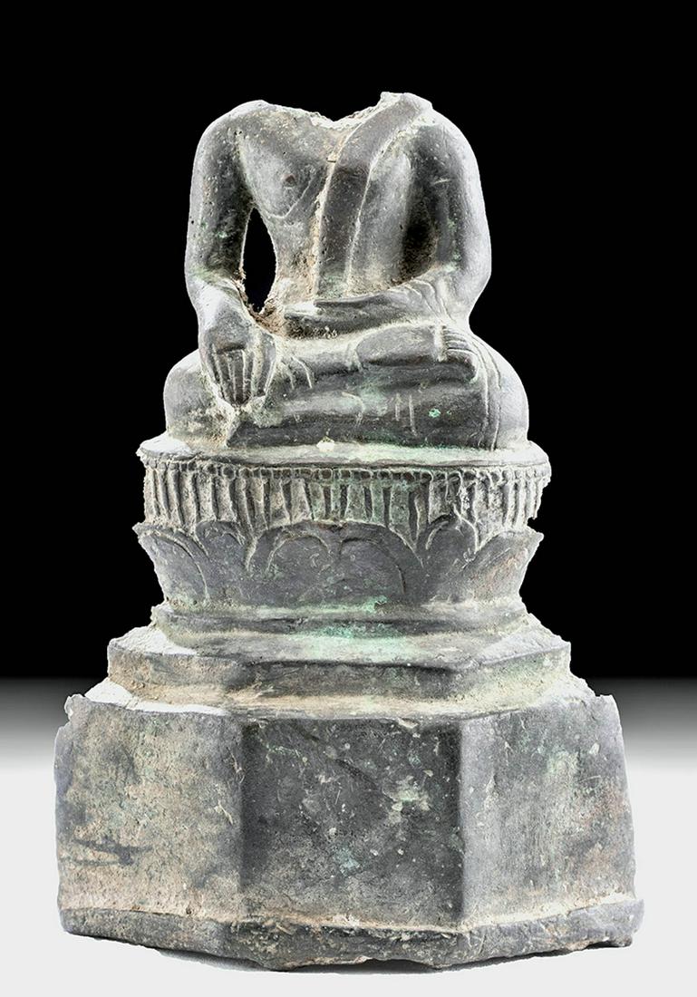 14th C. Khmer Bronze Shakyamuni Buddha: **Originally Listed At $300** Southeast Asia, Cambodia, Khmer culture, ca. 14th to 15th century CE. A cast-bronze depiction of a Shakyamuni Buddha seated with crossed legs atop a lotus flower plinth. 