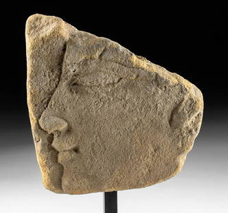 Egyptian Sandstone Relief of God / King, ex-Ede: Egypt, Ptolemaic Period, ca. 332 to 30 BCE. A gorgeous, hand-carved sandstone relief of rough trapezoidal form depicting the left-facing visage of a god or king. The masculine countenance exhibits a