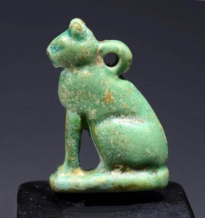 Egyptian Glazed Faience Pendant - Seated Bastet: Ancient Egypt, Late Dynastic to Ptolemaic Period, ca. 664 to 30 BCE. A mold-formed faience pendant of petite form depicting a majestic feline (Bastet?) seated upon thick haunches atop an integral