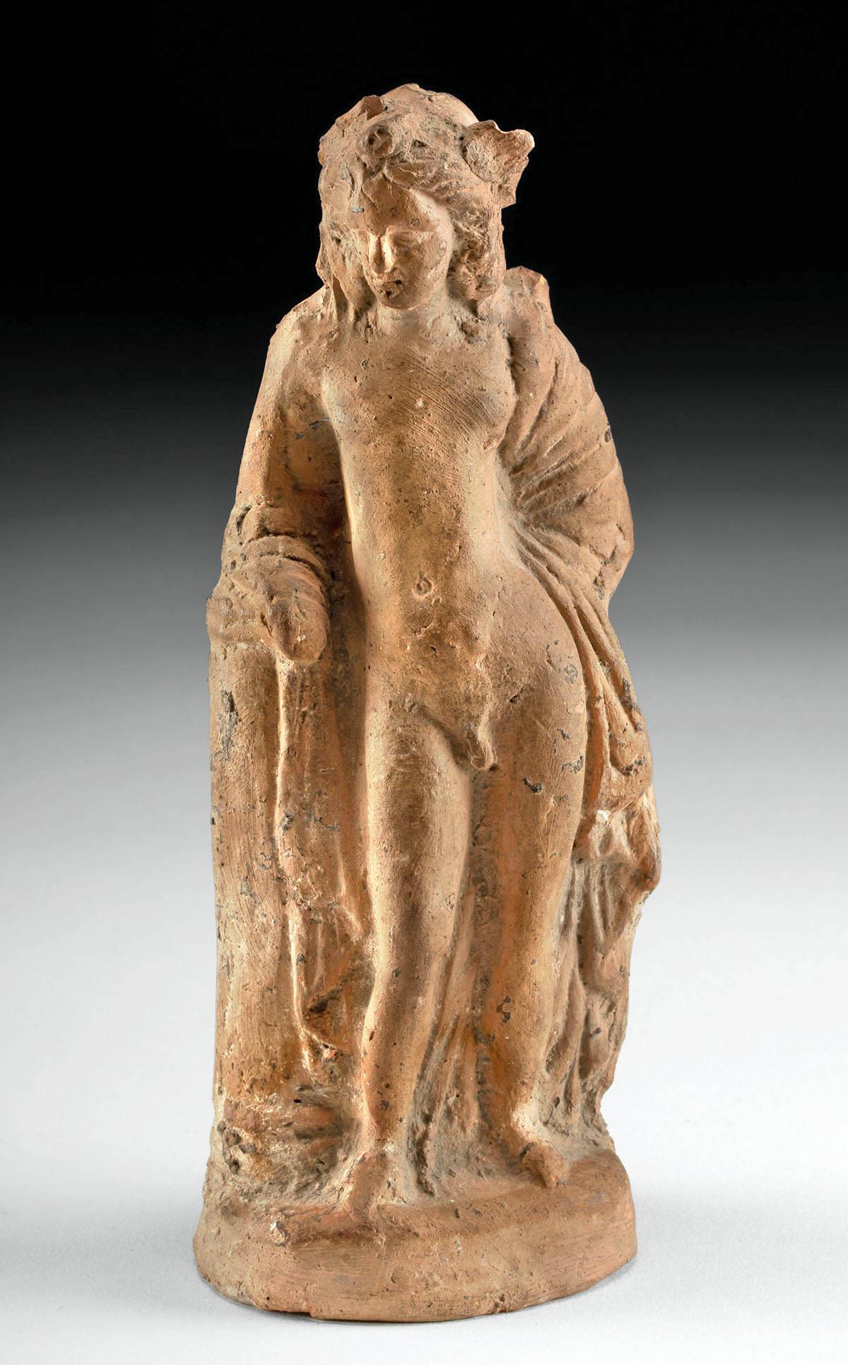 Greek Hellenistic Terracotta Figure of a Nude Eros: Greece, Hellenistic Period, ca. 3rd to 1st century BCE. A lovely terracotta figure of Eros, Greek god of love and desire, embodying the Classical ideal as he stands nude in contrapposto with the soft 