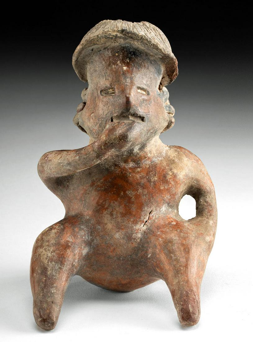 Nayarit Ixtlan Del Rio Redware Seated Figure: Pre-Columbian, West Mexico, Nayarit, Ixtlan Del Rio, Protoclassic period, ca. 100 BCE to 250 CE. A hand-built pottery figure seated with legs spread and nude, but of ambiguous gender. The elongated he