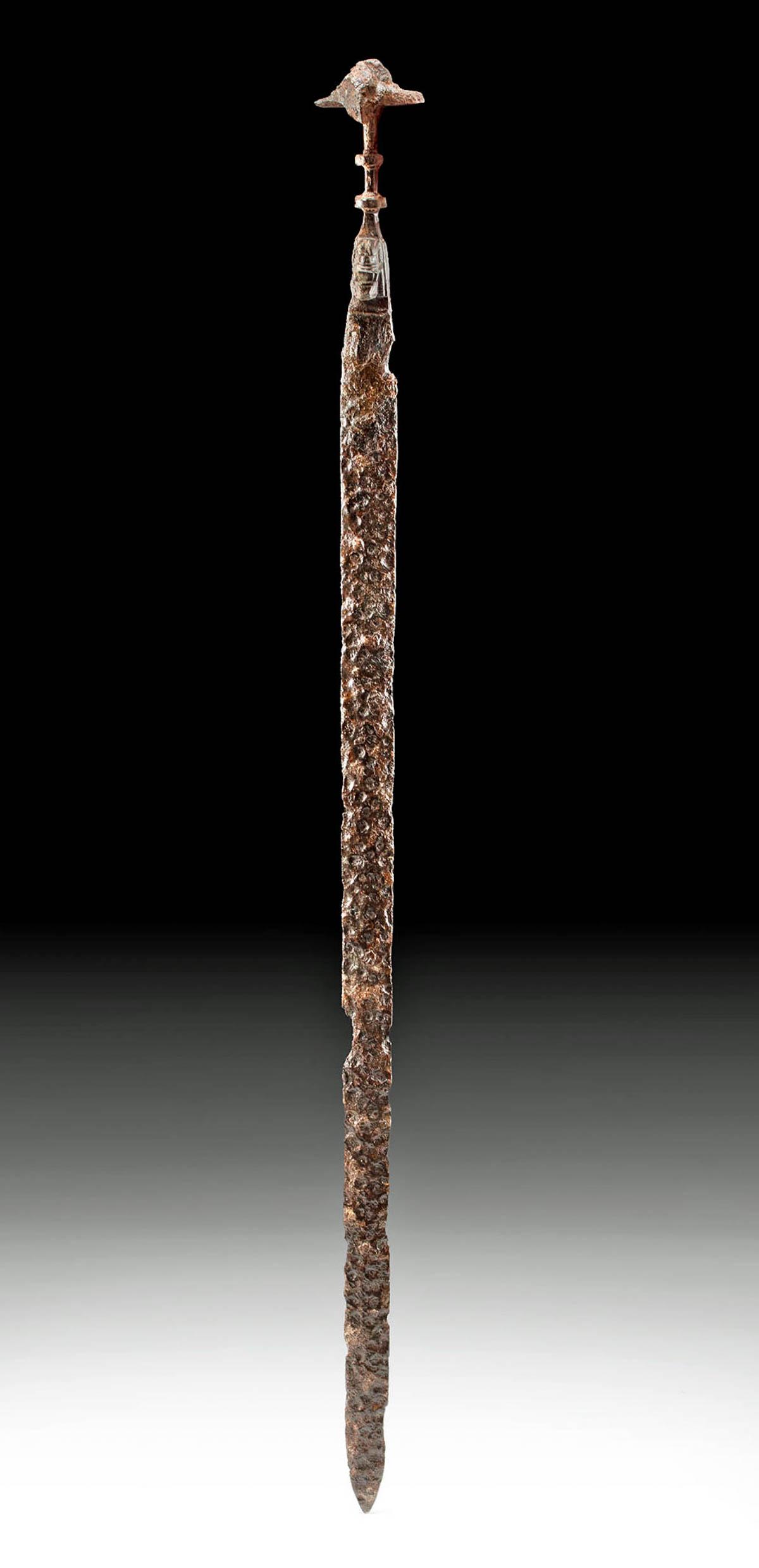 Rare Luristan Iron Sword w/ Janus Heads & Lions: Ancient Near East, Northwestern Iran and Southeastern Turkey, Luristan, ca. 750 to 650 BCE. A forged-iron sword of remarkable form with a lengthy blade bearing a thick shoulder, sharp edges, and a poi