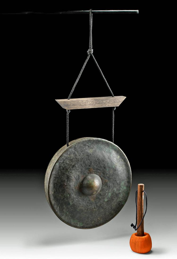 19th C. Burmese Bronze Temple Gong, Lotus Flower Patina: Southeast Asia, Burma / Myanmar, ca. 19th to early 20th century CE. A wonderful example of a playable bronze nipple gong that hangs from a mahogany wood and rope framework with a wooden mallet and a b