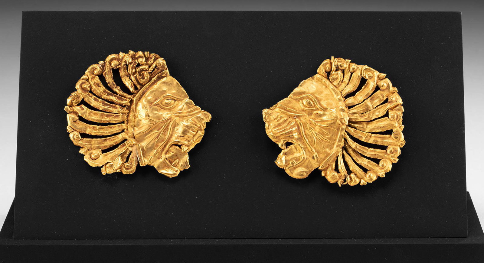 Superb Persian Achaemenid 23K+ Gold Lion Appliques: **Originally Listed At $5000** Near East, Iran, Achaemenid Empire, ca. 6th to 4th century BCE. A pair of 99% gold (equivalent to 23K+ to 24K) applique ornaments repousse formed into roaring lion heads