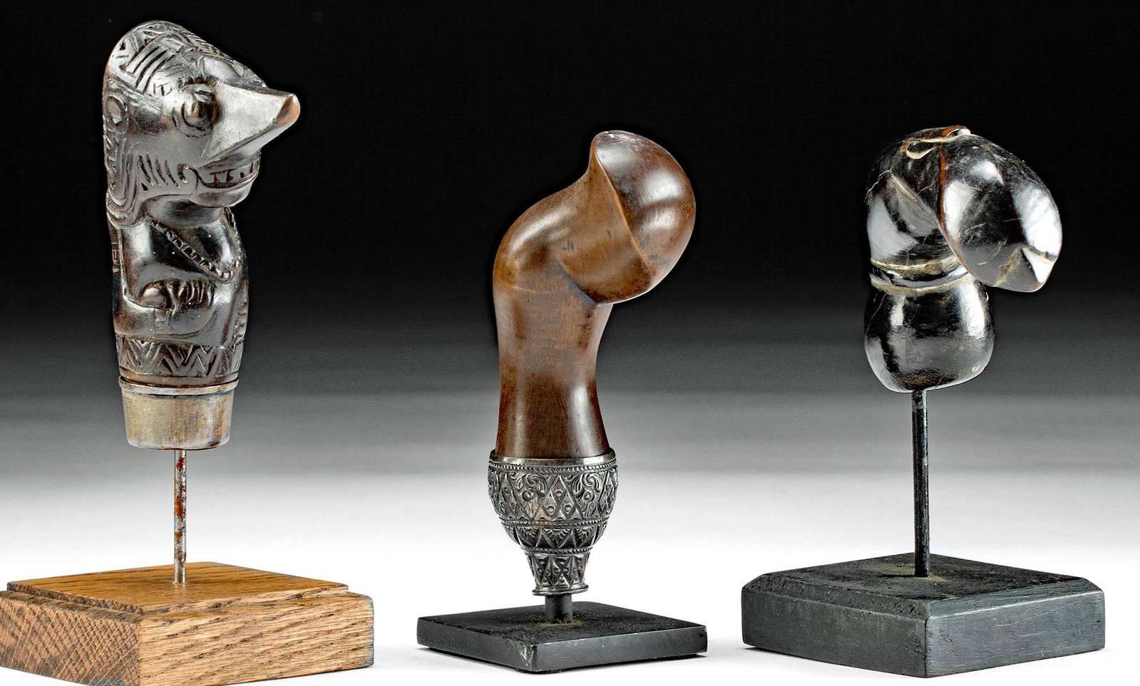 3 Indonesian Wood & Silver Kris Handles: **Originally Listed At $350** Southeast Asia, Indonesia, Java, ca. early to mid 20th century CE. A fine trio of hand-carved wood kris handles presenting hues of chocolate brown and espresso beneath a 