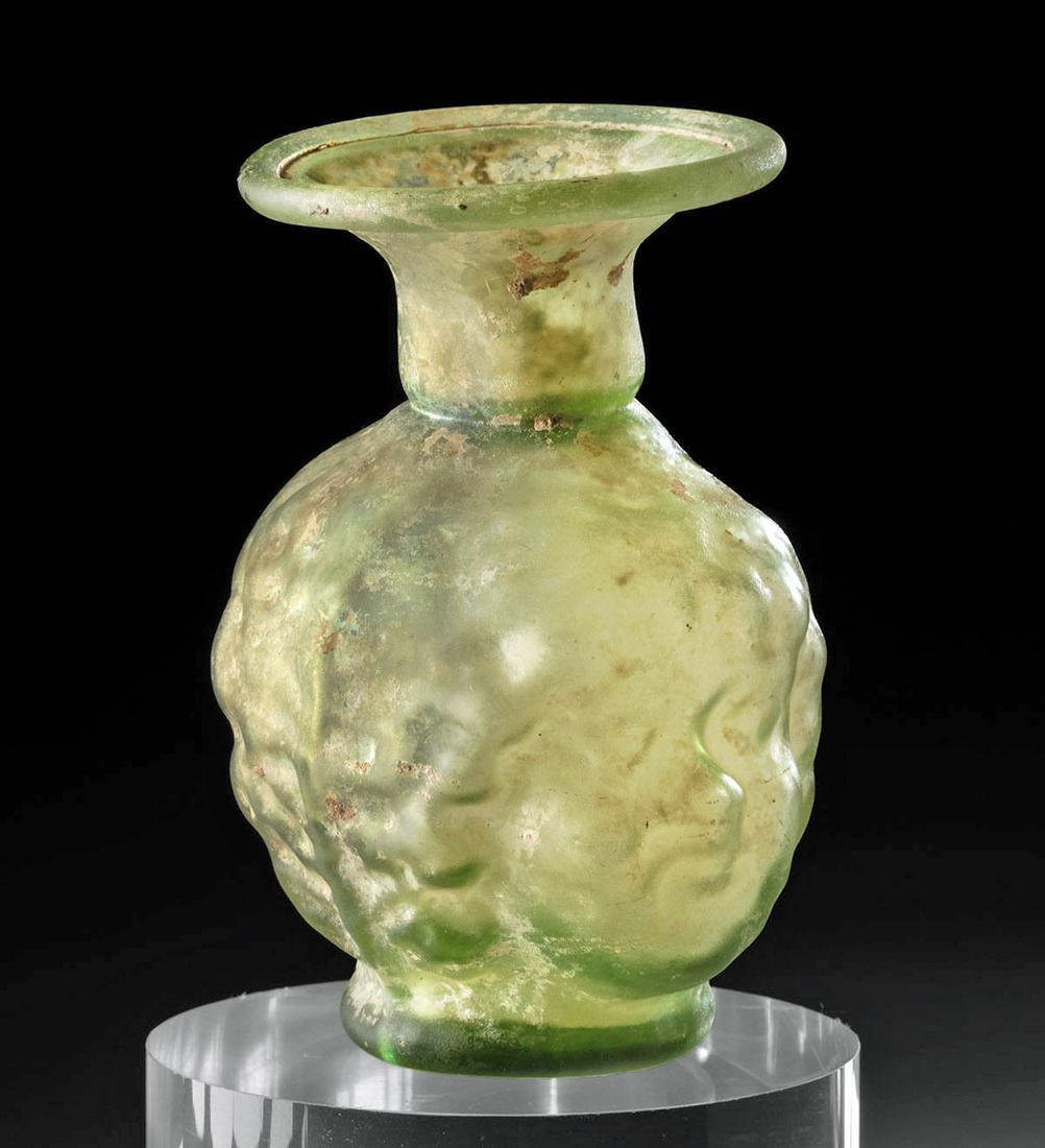 Exhibited / Published Roman Glass Flask, Janiform Head: **First Time At Auction** Roman, Late Imperial period, likely Sidonian culture, ca. 3rd to 4th century CE. A remarkable and rare sprinkler flask formed from translucent green glass to present a janifo