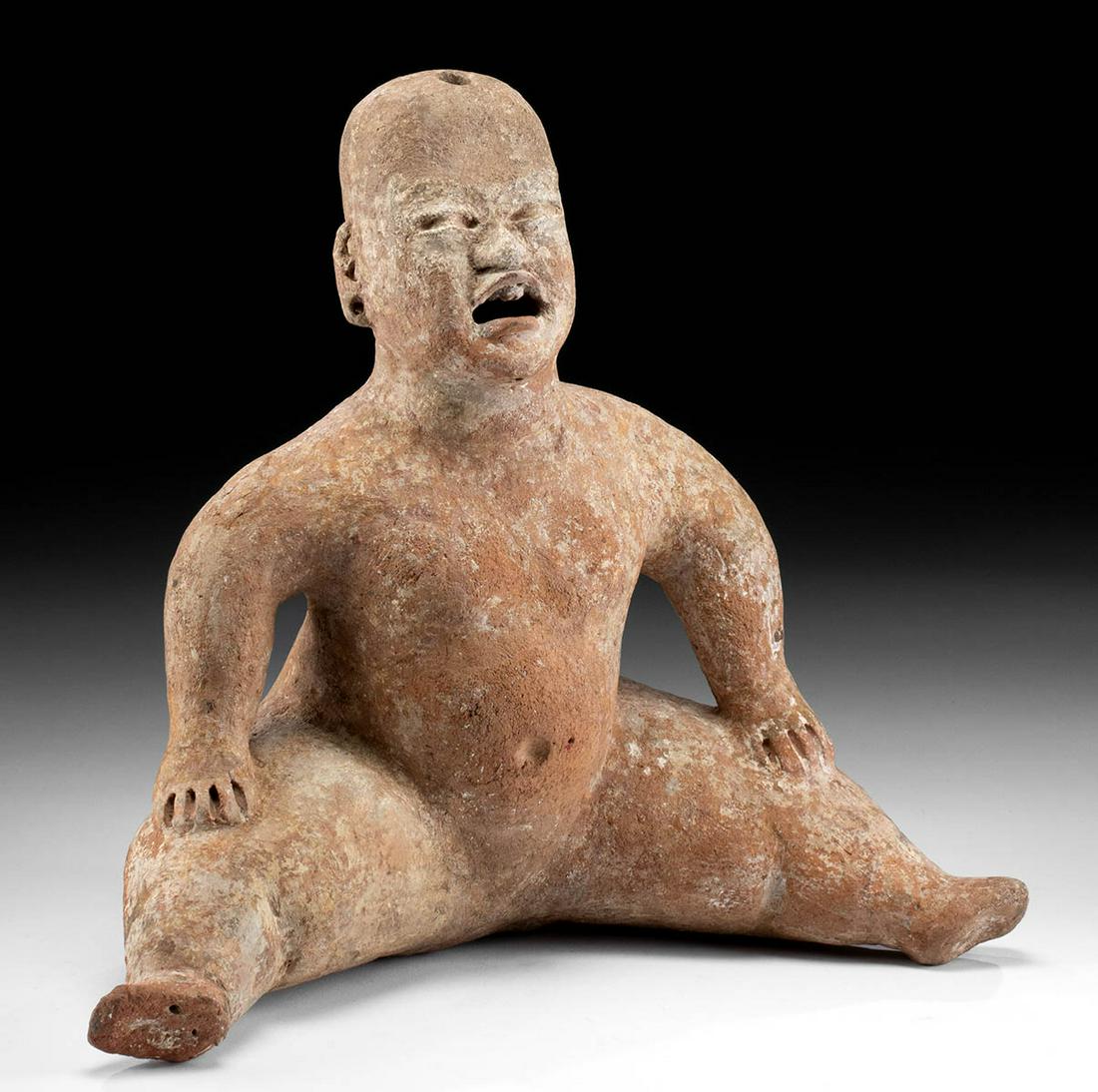 Olmec Terracotta Seated Baby Figure: **Originally Listed At $4000** Pre-Columbian, Mexico, Olmec culture, ca. 10th to 6th century BCE. A dramatic terracotta figure of a seated human baby, posed with legs akimbo and both hands resting on 