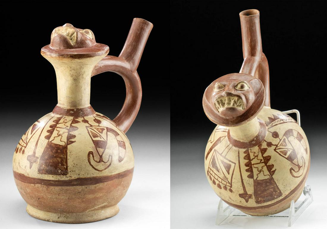 Moche Fineline Stirrup Vessel, Jaguar Head / Weapons: **Originally Listed At $750** Pre-Columbian, Central/North Coast Peru, Moche, Phase IV, ca. 450 to 650 CE. A fine example of a hand-built pottery stirrup vessel featuring fineline painted motifs and a