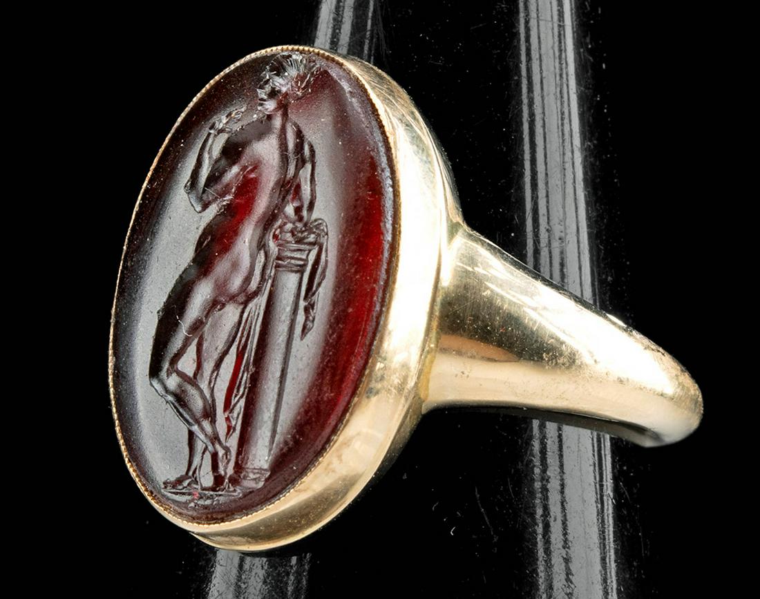 Neoclassical Gold Ring w/ Glass Intaglio of Nude Female: Western Europe, Neoclassical period, ca. 19th century CE. A stunning red glass intaglio of a female nude - perhaps Venus (Greek Aphrodite) the Roman goddess of love and beauty - set in a gold ring of