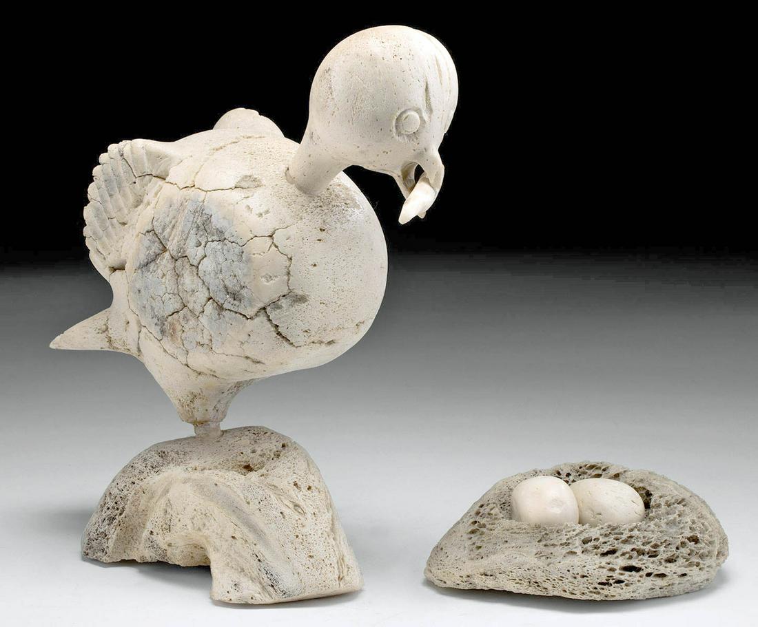 1970s Inuit Whalebone Sculpture Bird w/ Nest - Karoo Ashevak: Karoo Ashevak (First Nations, Inuk, 1940 to 1974), Mother Bird & Nest, whalebone, ca. 1970s CE. A whale bone carving of a mother bird perched on a base, a separate bone in her mouth, a twig for buildi