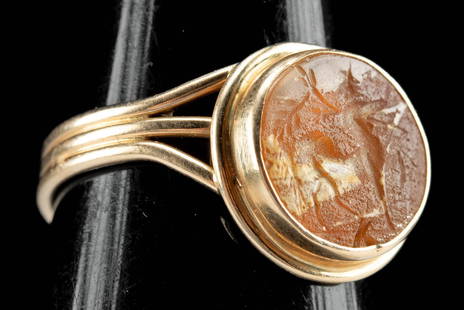 Gold Ring w/ Roman Paste Glass Intaglio of Centaur: Roman, Imperial period, ca. 1st to 3rd century CE. A beautiful paste glass intaglio featuring a centaur facing right and holding a spear or sword set in a modern, triple banded gold ring. Originating