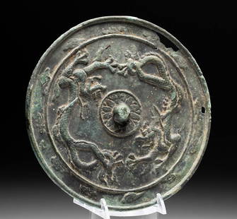 10th C. Korean Bronze Mirror w/ Dragons, Flowers: East Asia, South Korea, Goryeo / Koryo Dynasty, ca. 918 to 1392 CE. A beautiful, high-tin bronze mirror with a polished face, a petite handle, and an ornate back displaying a pair of dragons with a lo