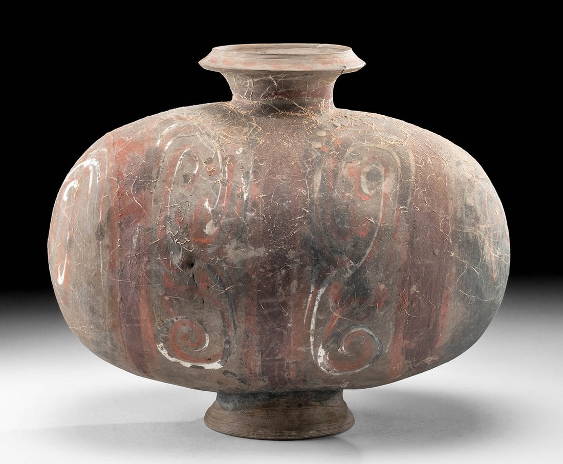 Fine Chinese Han Dynasty Pottery Cocoon Vase: East Asia, China, Western Han Dynasty, ca. 206 BCE to 220 CE. An egg or cocoon shaped vessel upon a foot, with a flared spout rising from the center of the upper body. The curvilinear motifs are paint