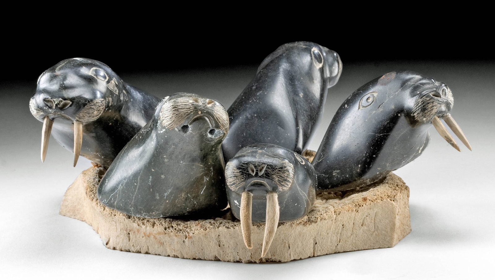Inuit Soapstone Carving - Walrus Torsos: Native American / First Nations, Northwest Coast United States, Alaska or Canada, Inupiaq / Inuit people, ca. mid to late 20th century CE. A sculpture of soapstone walrus heads atop a whalebone base,