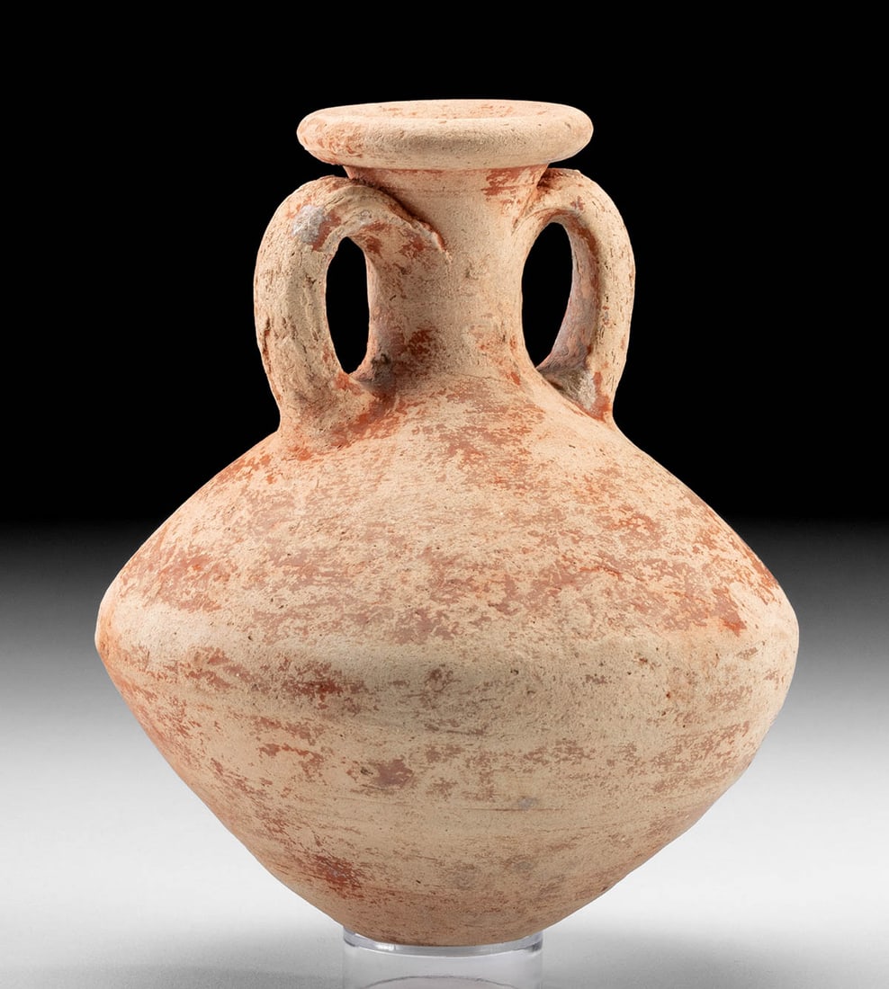 Exhibited Romano-Egyptian Pottery Amphora: Egypt, Romano-Egyptian period, ca. 30 BCE to 4th century CE. A lovely pottery amphora presenting a broad, carinated body surmounted a slender neck, a flared and rolled rim, and twin arching handles. A