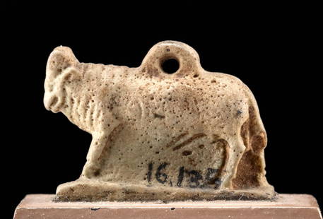 Museum-Exhibited Egyptian Faience Bull Amulet, ex-Mitry: Ancient Egypt, Late Dynastic to Ptolemaic Period, ca. 664 to 30 BCE. A faience charm in the form of the bull deity, Apis, with carefully molded and etched details. The divine bovine strides forward at