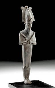 Egyptian Ptolemaic Bronze Osiris, Museum-Exhibited: Ancient Egypt, Ptolemaic Period, ca. 332 to 30 BCE. A cast-bronze figure of Osiris, the god of the Underworld, who stands in mummiform while holding his signature heka scepter and flagellum (nekhakh)