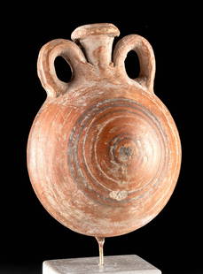 Exhibited Egyptian Pilgrim's Flask w/ Bullseye, ex MIA: Ancient Egypt, Late Dynastic Period, 26th to 31st Dynasty, ca. 664 to 332 BCE. A hand-built pottery pilgrim flask of sizable form bearing russet-hued surfaces decorated with black-painted bullseye