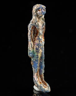 Published Egyptian Blue Glass Striding Figure Amulet: Ancient Egypt, New Kingdom, 18th to 20th Dynasty, ca. 1550 to 1070 BCE. An incredibly rare, hand-built glass amulet depicting a figurine standing with arms to their sides. The wear to the facial