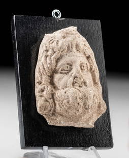 Published Romano-Egyptian Serapis Head, ex-Lily Place: Ancient Egypt, Ptolemaic to Romano-Egyptian Period, ca. 2nd century BCE to 2nd century CE. A hand-built plaster head of Serapis, god of fertility and the afterlife, a Graeco-Egyptian god who first app