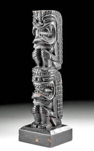 1920s Hawaiian Hardwood Tiki Totem, Two Figures: North America, Hawaiian Islands, ca. 1920s CE. A gorgeous tiki totem, hand-carved from hardwood and colored with natural black pigment. The totem depicts a pair of expressive Hawaiian deities, one kne