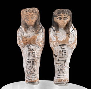 Exhibited Pair of Egyptian Ushabti for Amennioutnakht: Ancient Egypt, Third Intermediate Period, 21st Dynasty, ca. 1070 to 943 BCE. A stunning pair of ushabti inscribed for an individual of importance named Amennioutnakht. Each white-painted shabti