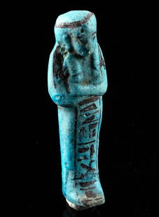 Exhibited Egyptian Faience Ushabti for Penebenkemenekht: Ancient Egypt, Third Intermediate Period, 21st Dynasty, ca. 1070 to 943 BCE. A mold-formed faience ushabti exhibiting a mummiform presentation that is enveloped with layers of blue glaze.