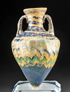 Greek Core-Formed Glass Amphoriskos: Ancient Greece, Classical period, ca. 5th century BCE. A beautiful example of a core-formed glass amphoriskos (miniature amphora) once used to hold perfumed oils. The near-miniature vase boasts an