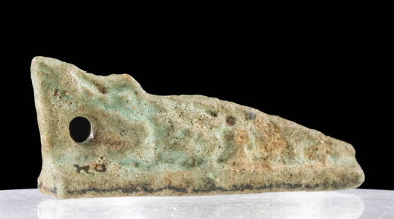 Published / Exhibited Egyptian Faience Crocodile Amulet: Ancient Egypt, Late Dynastic to Ptolemaic Period, ca. 664 to 30 BCE. A mold-formed faience crocodile amulet covered in turquoise-hued glaze. The slender reptile lays atop an integral plinth with its h