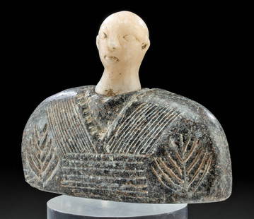 Bactrian Stone Idol Figure w/ Marble Head: Central Asia, Bactria-Margiana (BMAC) (Oxus Civilization), Bronze Age, ca. 3000 to 2000 BCE. A idol figure hand-carved from a dark gray stone, the surface incised with triangular and linear motifs tha