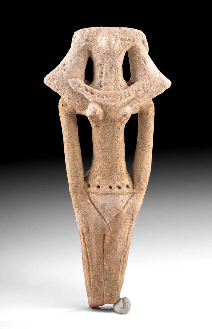 Rare Egyptian Middle Kingdom Pottery Female Figure: Ancient Egypt, Middle Kingdom to Second Intermediate Period, 12th to 17th Dynasty, ca. 1991 to 1550 BCE. A hand-built pottery female figure of highly stylized form shown standing atop fused legs. The 
