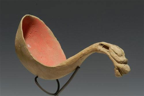 A Chinese Han Dynasty Painted Pottery Ladle: China, Han Dynasty, 206 B.C. - 220 A.D. terracotta dipping piece, handle terminating in a dragon's head finial, painted in orange and red pigment. 5"L. Provenance: Ex-D. Smith Collection, CA acquired