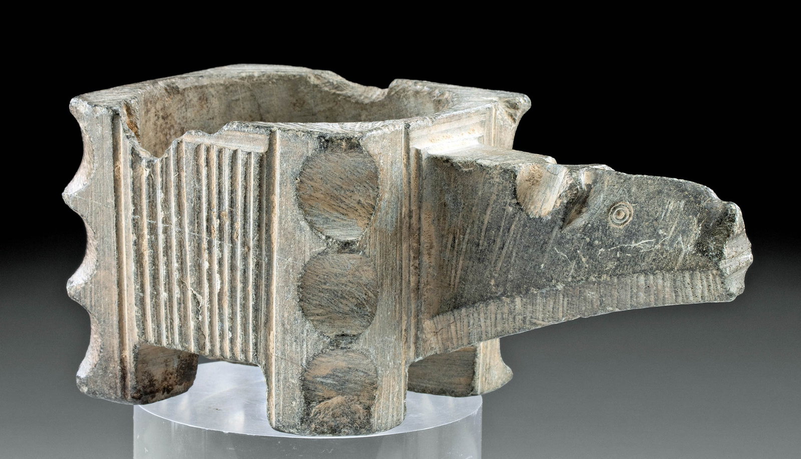 Ancient Bactria Chlorite Schist Censer Vessel - Bovid: Central Asia, Eastern Iran / Afghanistan, Bactria, ca. 2000 to 1500 BCE. A handsome gray chlorite schist censer vessel with a cuboid body and elongated handle in the form of an animal. The center is d