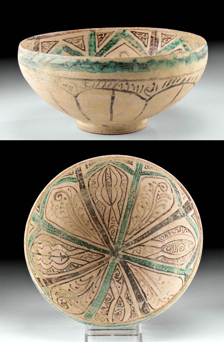 12th C. Islamic Nishapur Glazed Pottery Bowl: Medieval Near East/Western Asia, Persia (Iran), Nishapur, ca. 12th century CE. A beautiful pottery bowl featuring a deep basin and convex walls painted with elaborate floral motifs in hues of black an