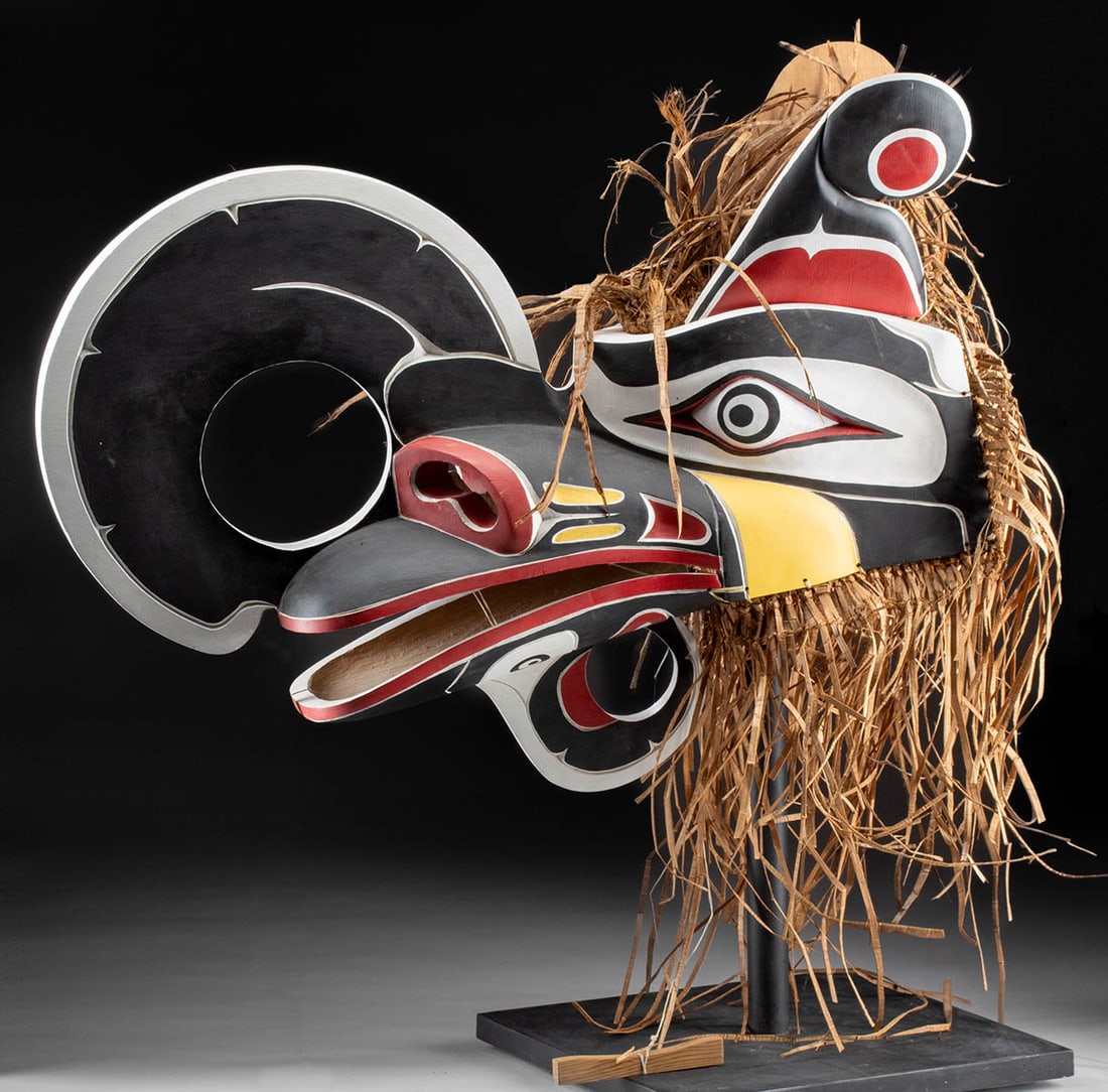 NW Coast Salish Mask, "Crooked Beak" by George Price: George Price (Coast Salish / Kwakiutl, b. 1960). "Crooked Beak" painted wood and raffia mask, ca. early 21st century. Not signed. A dramatic, hand-carved wooden mask representing the bird-monster call