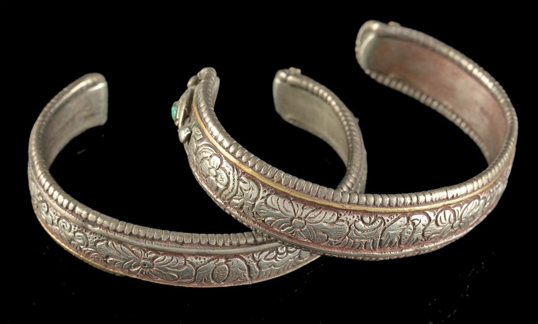 Nepalese / Indian Silver Cuff Bracelets (pr): **Originally Listed At $300** Central Asia, Himalayan region, Nepal / Northern India, ca. early to mid-20th century CE. A matching pair of brass and silver cuff bracelets with engraved floral motifs a