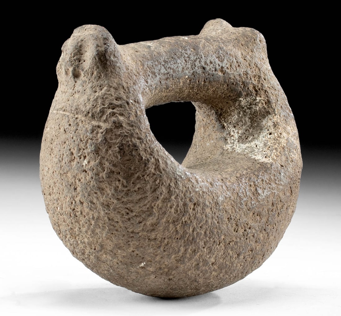 Maya Basalt Manopla w/ Animal Handle (Hand Grip): Pre-Columbian, Southern Mexico to Guatemala, Maya, Classic Period, ca. 250 to 900 CE. A hand-carved basalt manopla, a hand grip used during play of the Maya Ballgame. This is an intriguing example due