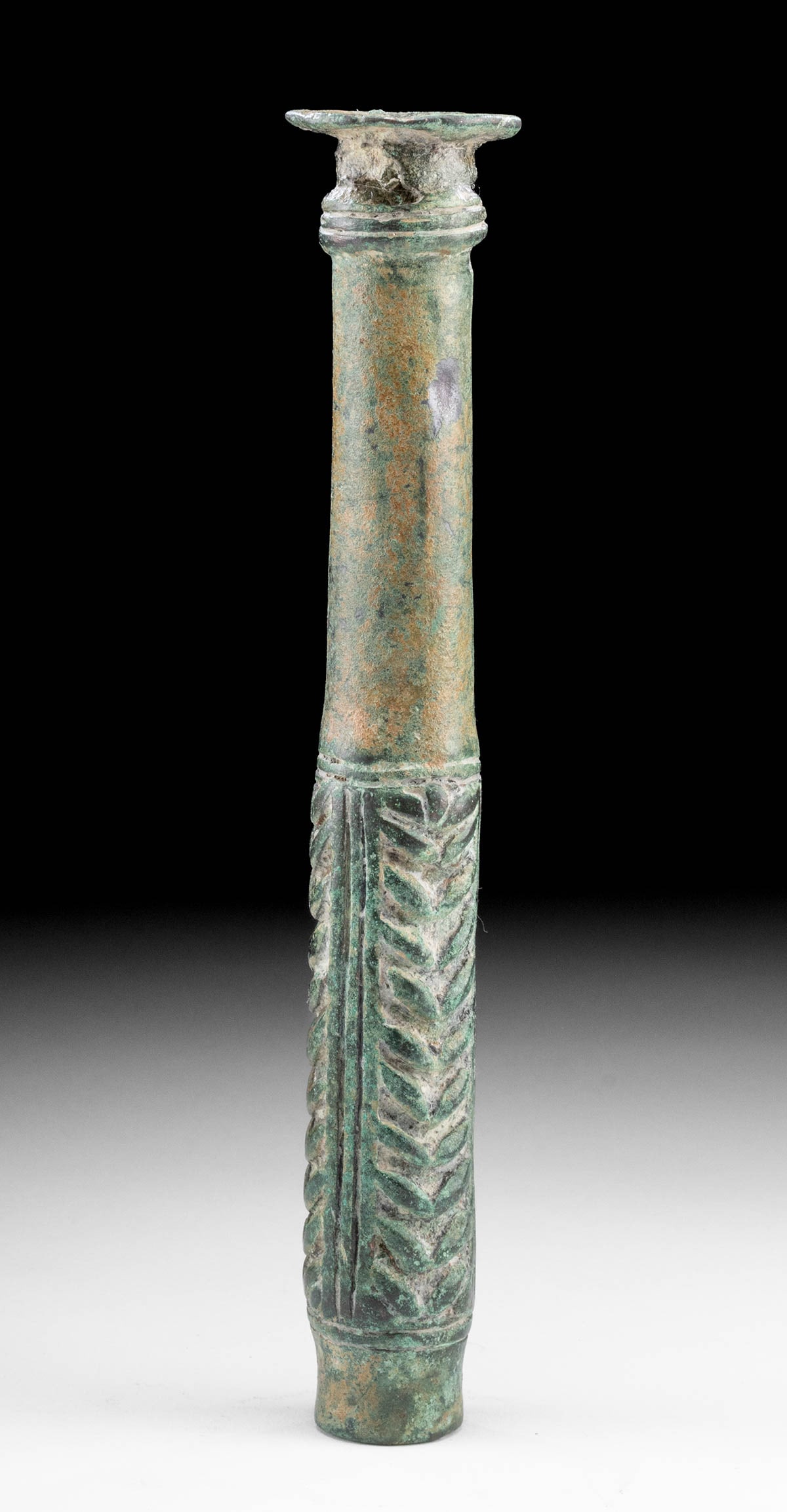 Ancient Luristan Bronze Cudgel / Weapon: Ancient Near East, Northwestern Iran, Luristan, ca. 1200 to 800 BCE. A cast-bronze cudgel with fine layers of green and brown patina. The cylindrical weapon features a smooth handle, a gently flared l