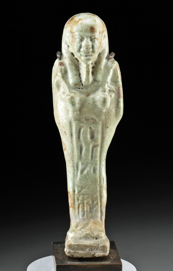 Egyptian Faience Ushabti w/ Inscription for Hori: Ancient Egypt, Ptolemaic Period, ca. 332 to 30 BCE. A mold-formed faience ushabti bearing a concise inscription for a man named Hori. The funerary figure is covered in pale green glaze while holding a