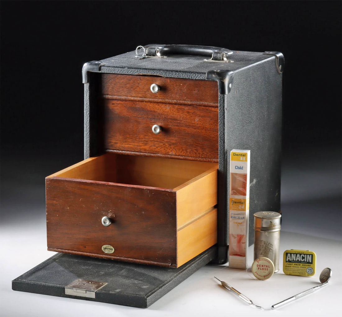 Vintage Wood Gerstner Travel Cabinet w/ Dentist Tools: North America, United States, Ohio, ca. early to mid-20th century CE. A three wooden oak drawer dentistry kit inside a protective black leather traveling case, by Gerstner and Sons of Dayton Ohio. The