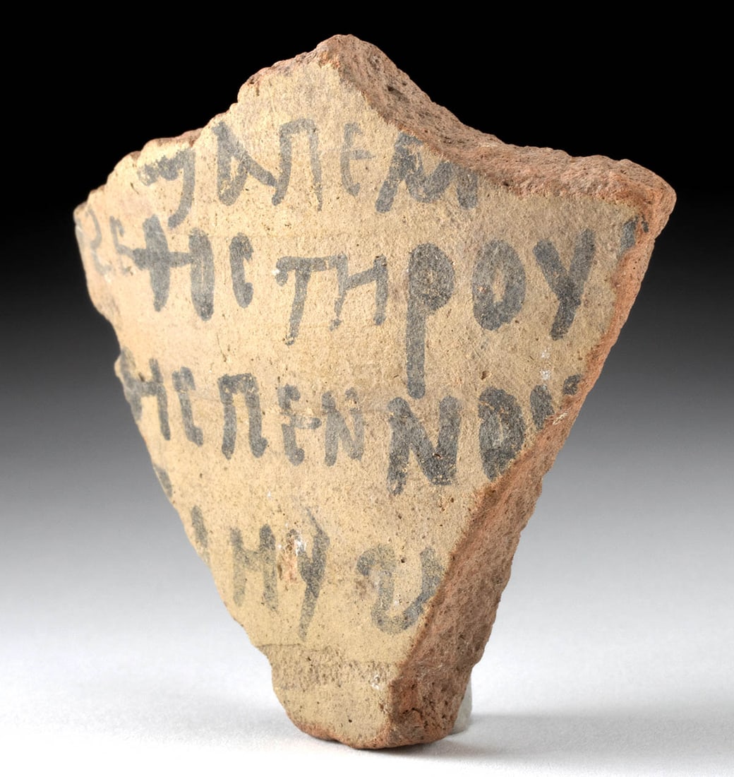 Egyptian Ptolemaic Pottery Ostracon: Egypt, Ptolemaic period, ca. 3rd to 1st century BCE. A fascinating pottery shard inscribed with 4 lines of ancient Greek script in black ink on beige slip. Ostraca are pieces of pottery, usually from 